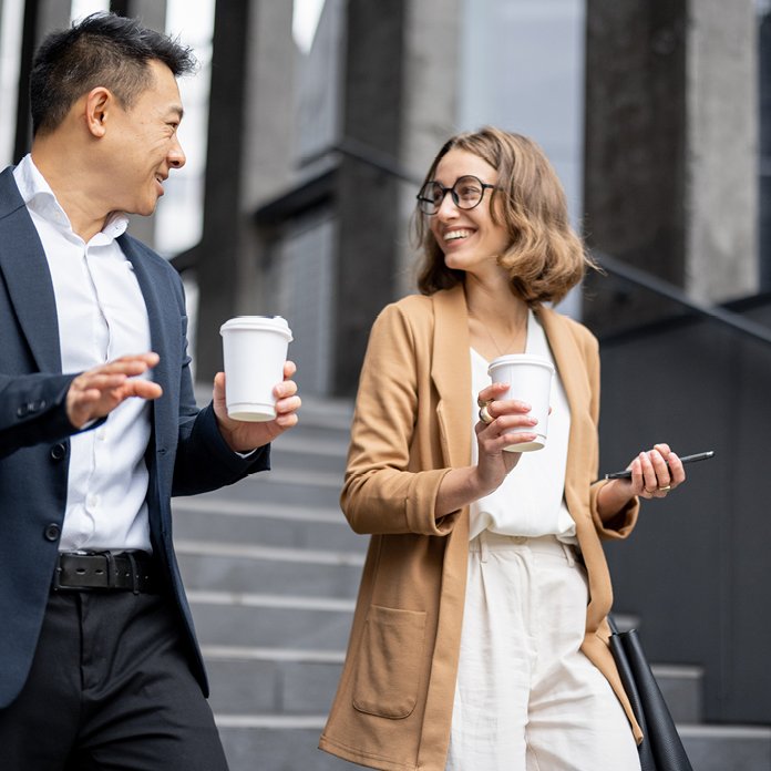 Business professionals walking with coffee